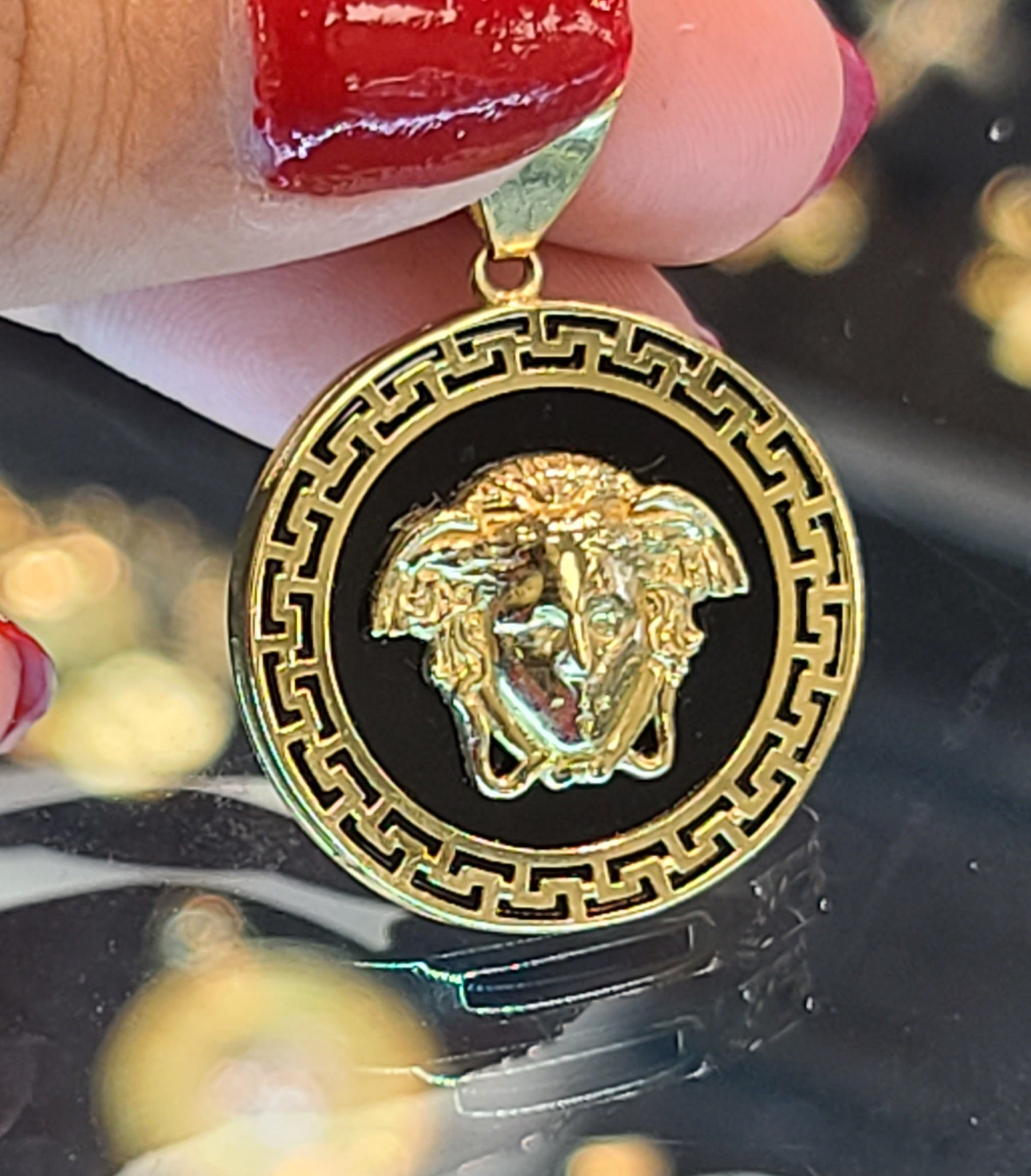Small Yellow Gold Circular Pendant with Medusa and Reflective Background